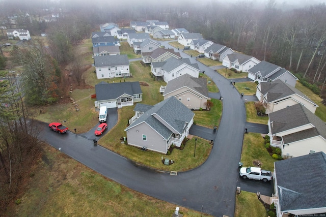 aerial view of property and surrounding area featuring nearby suburban area