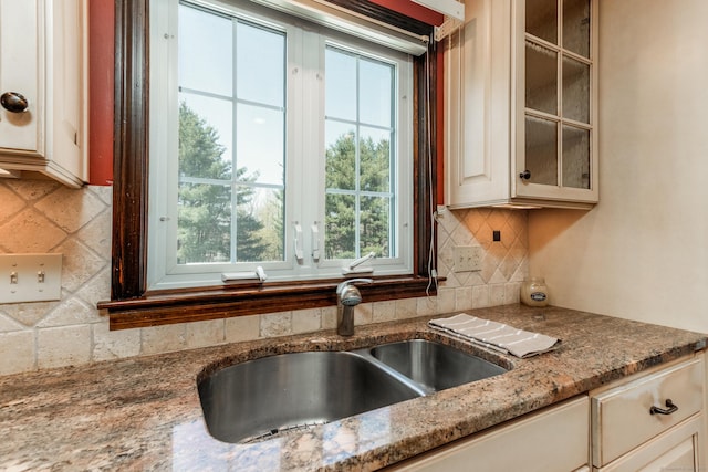 14 Valley View Dr, Wallingford, CT 06492 - kitchen featuring tasteful backsplash, cream cabinets, a sink, light stone counters, and glass insert cabinets