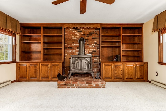 14 Valley View Dr, Wallingford, CT 06492 - unfurnished living room with ceiling fan, light carpet, baseboards, and a wood stove