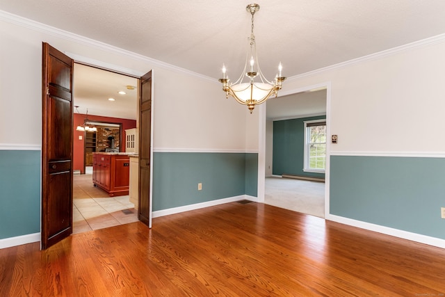 14 Valley View Dr, Wallingford, CT 06492 - empty room featuring an inviting chandelier, light wood-style flooring, baseboards, and crown molding