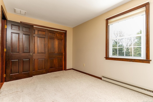 14 Valley View Dr, Wallingford, CT 06492 - unfurnished bedroom with visible vents, a closet, light carpet, baseboards, and a baseboard heating unit