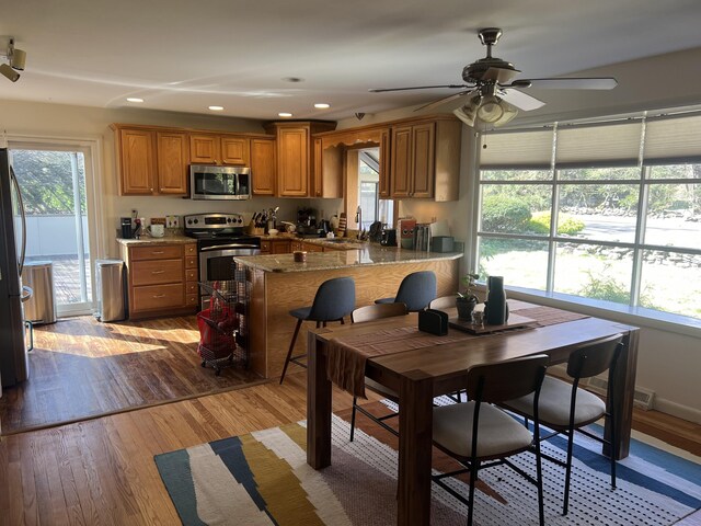 12 Fox Rd, Trumbull, CT 06611 - kitchen with appliances with stainless steel finishes, brown cabinets, ceiling fan, light wood finished floors, and recessed lighting