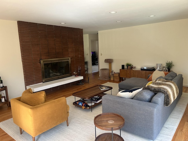 12 Fox Rd, Trumbull, CT 06611 - living room with wood finished floors, a brick fireplace, and recessed lighting