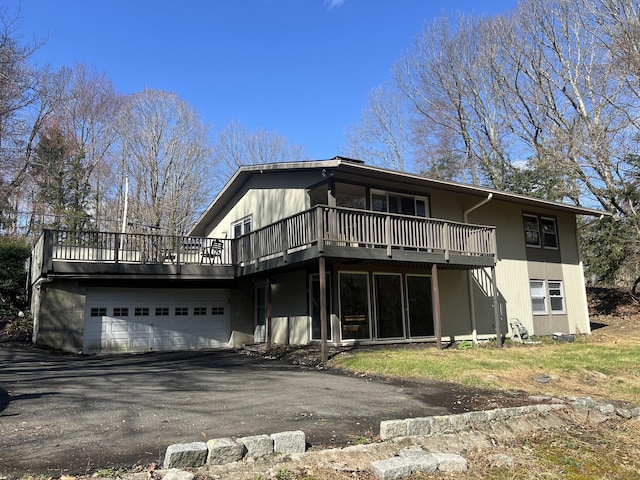 12 Fox Rd, Trumbull, CT 06611 - back of house featuring a wooden deck, an attached garage, and asphalt driveway