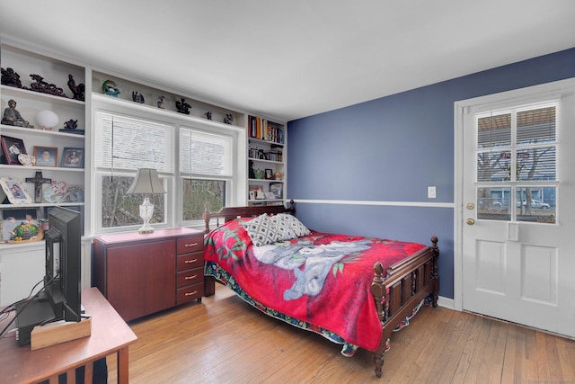 bedroom with light wood-style floors and baseboards
