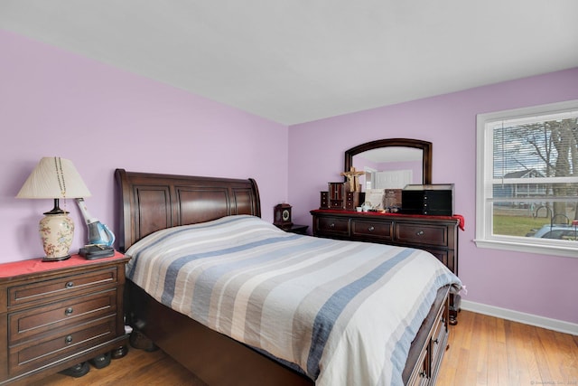 bedroom featuring light wood-style flooring and baseboards