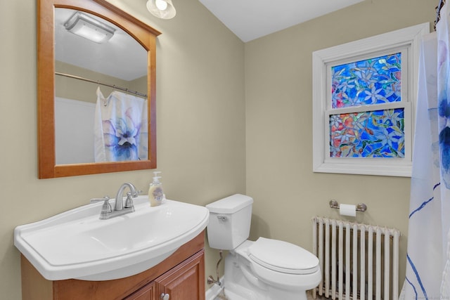 full bath featuring toilet, vanity, and radiator