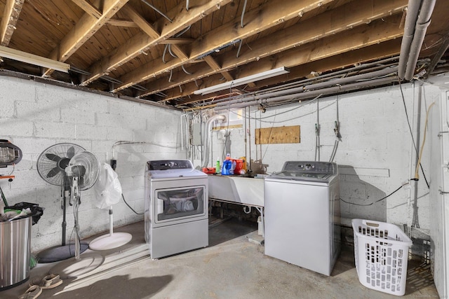 unfinished basement with a sink and washer and clothes dryer