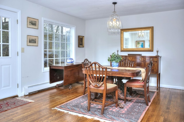 dining room with baseboards, wood finished floors, a chandelier, and a baseboard radiator