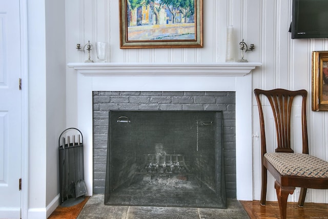 interior details featuring a fireplace with flush hearth and baseboards