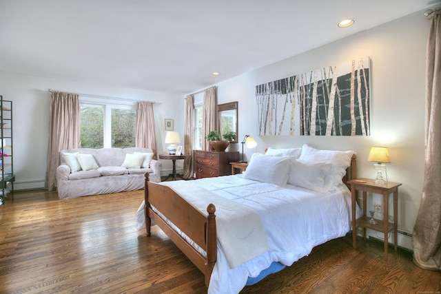 bedroom featuring recessed lighting, wood finished floors, and a baseboard heating unit