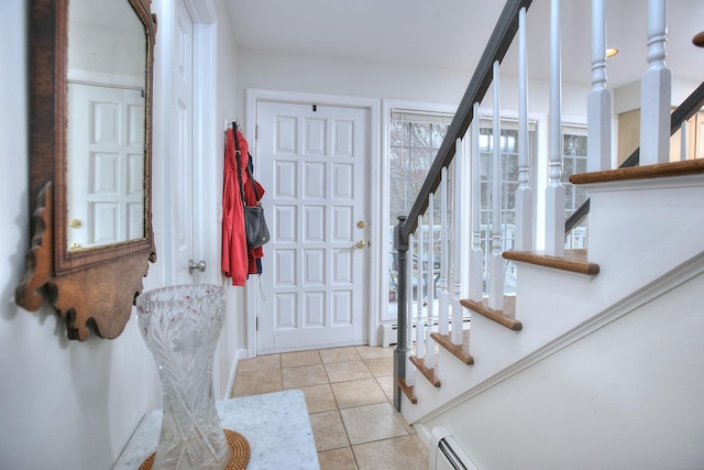 tiled foyer entrance featuring stairs and a baseboard radiator
