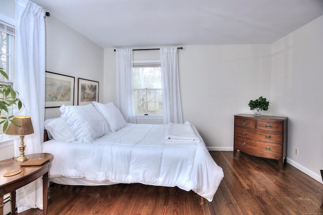 bedroom featuring wood finished floors and baseboards