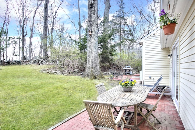 view of yard with outdoor dining area and a patio area