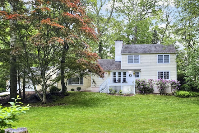 1 Graystone Ln, Weston, CT 06880 - rear view of house with a wooden deck, a lawn, and a chimney