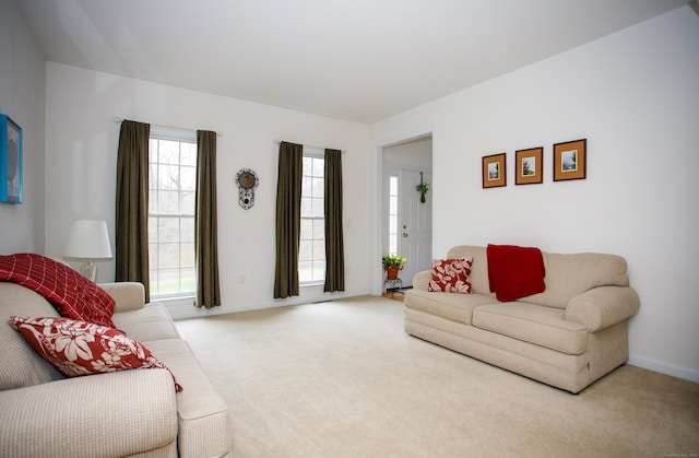 living room featuring carpet flooring and baseboards