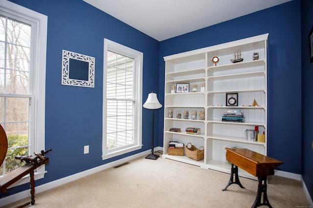 interior space featuring visible vents, a healthy amount of sunlight, carpet flooring, and baseboards