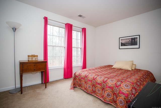 bedroom featuring baseboards, visible vents, multiple windows, and carpet flooring