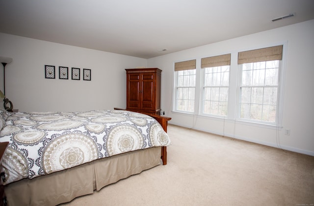 bedroom featuring visible vents, carpet flooring, and baseboards