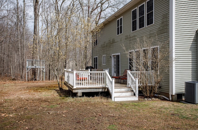 back of house with a deck and central air condition unit
