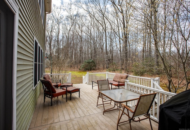 wooden terrace featuring an outdoor hangout area and grilling area