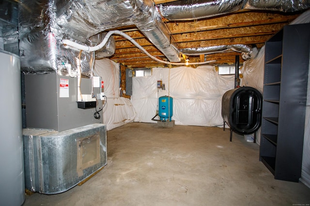 below grade area with heating fuel, electric panel, and water heater