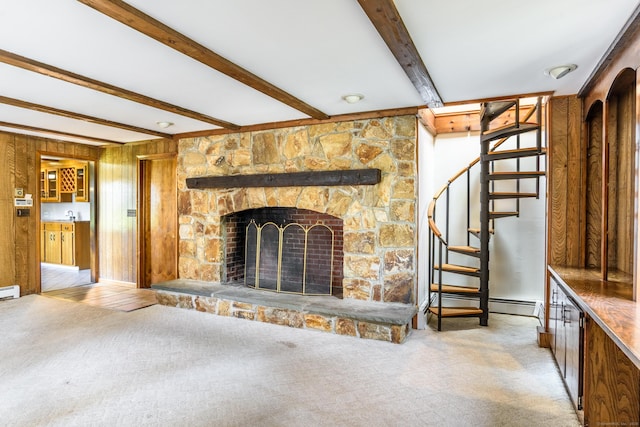 unfurnished living room featuring beamed ceiling, stairs, a stone fireplace, carpet, and baseboards