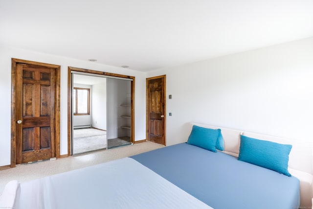 bedroom featuring baseboards, a closet, and a baseboard radiator