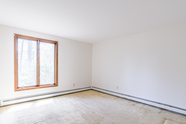 empty room with a baseboard heating unit and carpet flooring