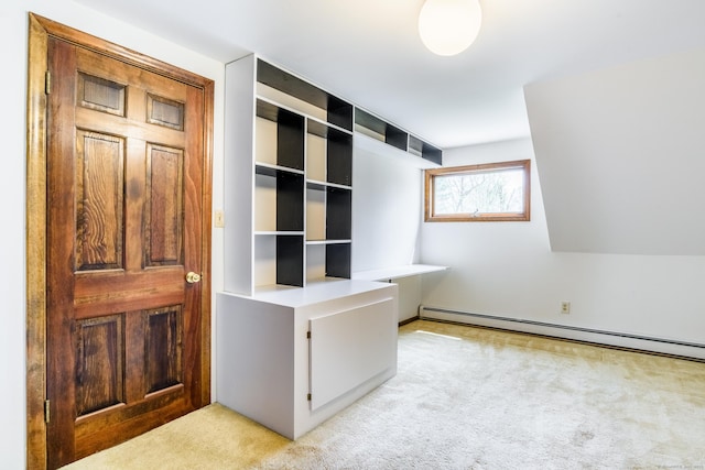 unfurnished office featuring baseboard heating and light colored carpet