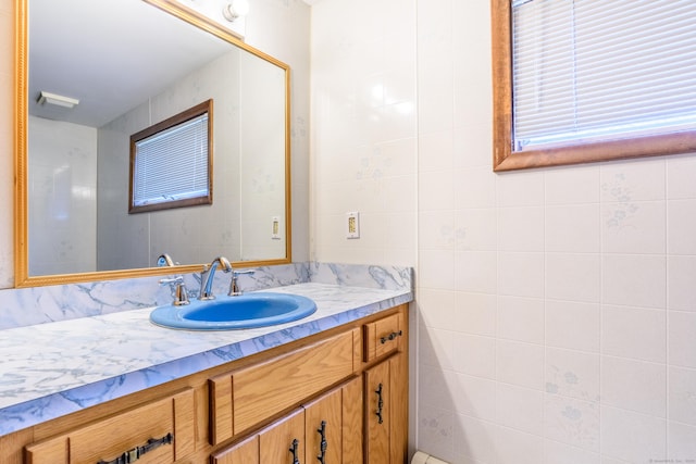 bathroom with tile walls and vanity