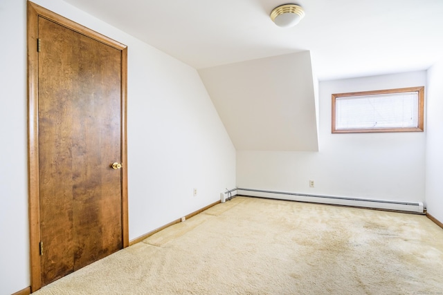 additional living space with carpet flooring, a baseboard heating unit, and baseboards