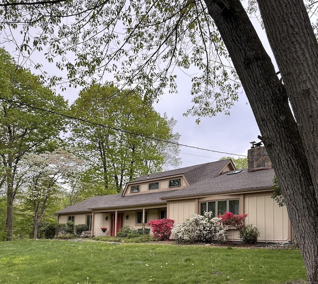 65 Cloverdale Ave, Shelton, CT 06484 - view of front of house with a chimney, a front lawn, a shingled roof, and board and batten siding