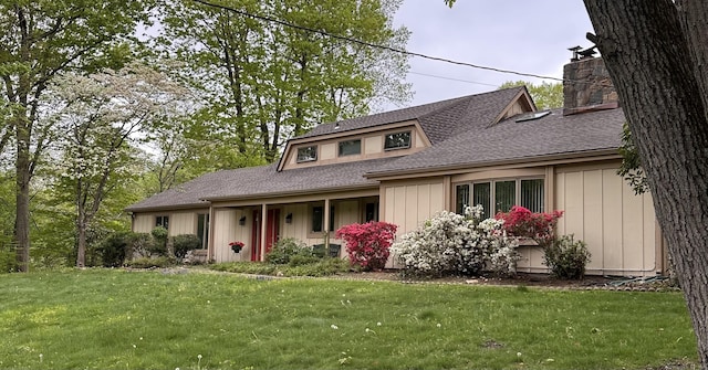 65 Cloverdale Ave, Shelton, CT 06484 - view of front facade featuring roof with shingles, a front lawn, and a chimney