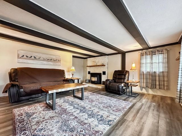 living room featuring a fireplace, wood finished floors, and beam ceiling