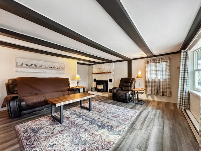 living room with beam ceiling, wood finished floors, baseboard heating, and a fireplace