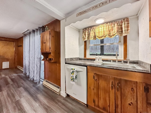 bar featuring dark wood-style flooring, dishwasher, a sink, a baseboard heating unit, and a textured wall