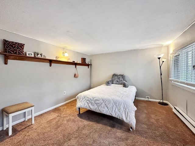 bedroom with carpet floors, baseboards, and baseboard heating