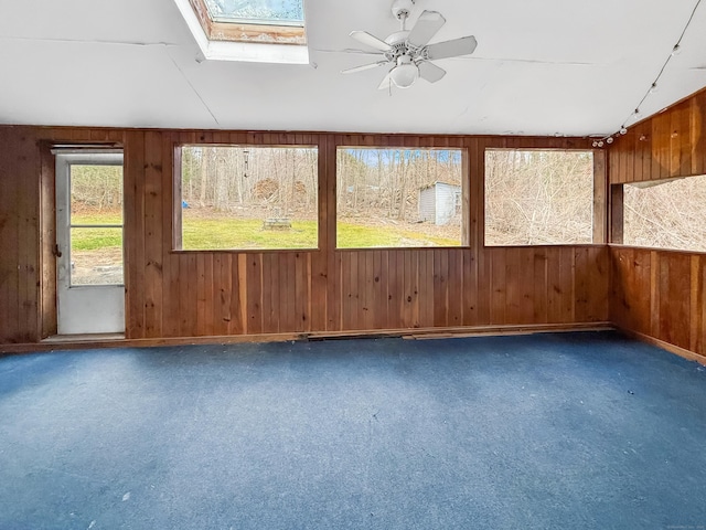 unfurnished sunroom featuring a skylight