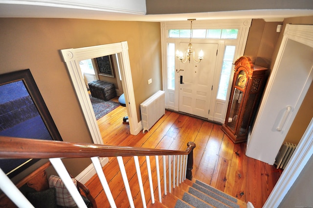 794 Main St, Somers, CT 06071 - entrance foyer with radiator, hardwood / wood-style flooring, a chandelier, and stairway