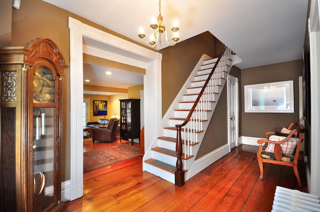 794 Main St, Somers, CT 06071 - stairs with a chandelier, wood-type flooring, and baseboards