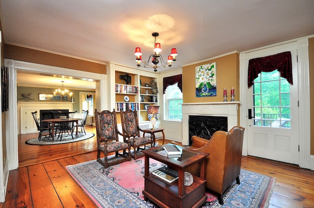 794 Main St, Somers, CT 06071 - living room with a chandelier, a fireplace, hardwood / wood-style flooring, ornamental molding, and healthy amount of natural light