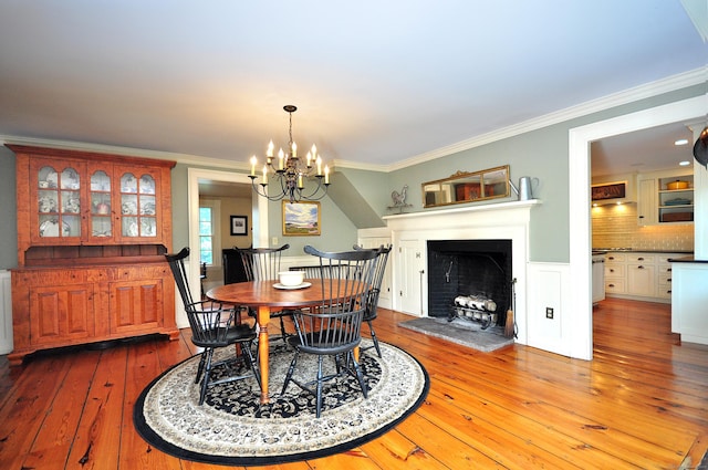 794 Main St, Somers, CT 06071 - dining room with hardwood / wood-style floors, crown molding, a chandelier, and a fireplace