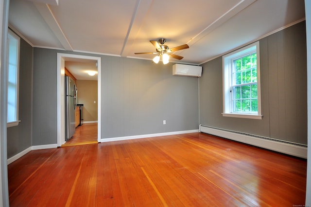 794 Main St, Somers, CT 06071 - spare room featuring a baseboard heating unit, an AC wall unit, ornamental molding, wood-type flooring, and a ceiling fan
