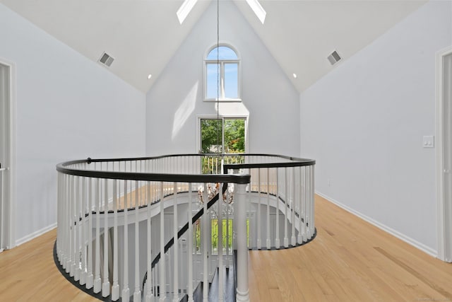 5 Tall Oaks Rd, Wilton, CT 06897 - corridor with an upstairs landing, high vaulted ceiling, a skylight, and wood finished floors