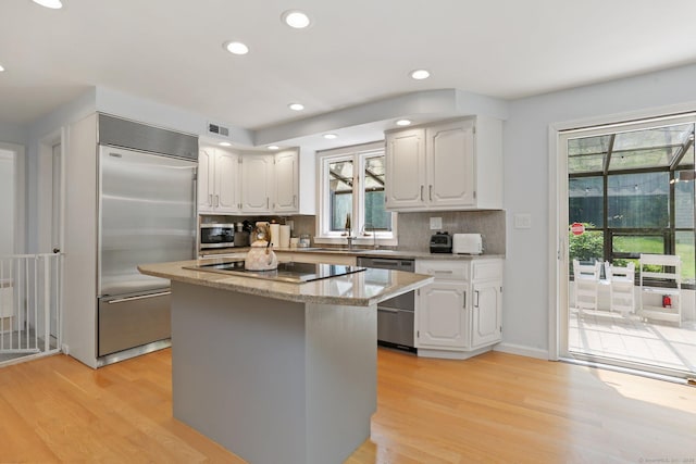 5 Tall Oaks Rd, Wilton, CT 06897 - kitchen with stainless steel appliances, plenty of natural light, light wood-style flooring, a kitchen island, and recessed lighting