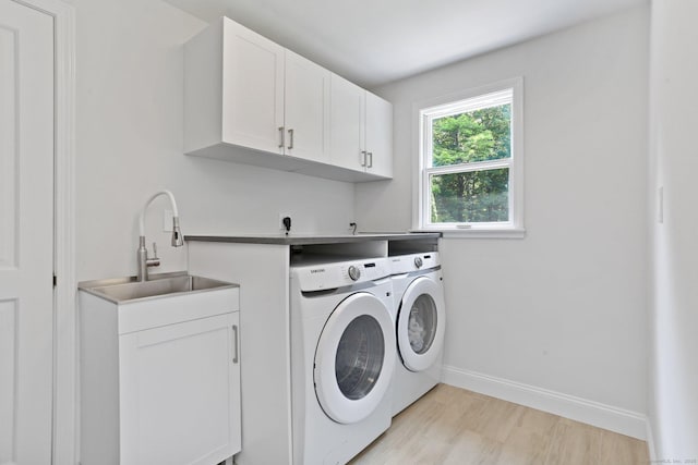5 Tall Oaks Rd, Wilton, CT 06897 - washroom with cabinet space, washing machine and clothes dryer, and light wood finished floors