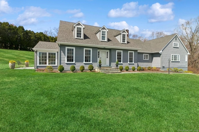 cape cod house with a front lawn and a shingled roof