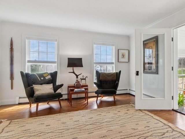 sitting room featuring crown molding and wood finished floors