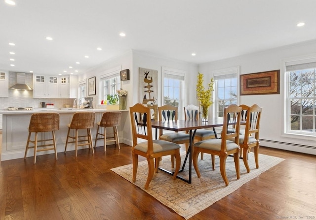 dining room with dark wood-type flooring, recessed lighting, and baseboards